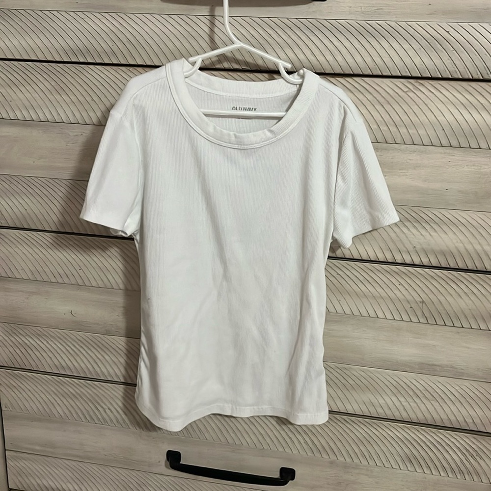 Girls white small old navy shirt the material is ribbed knit and logo is peeling